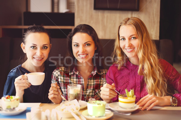 Three young women at a meeting in a cafe Stock photo © dashapetrenko