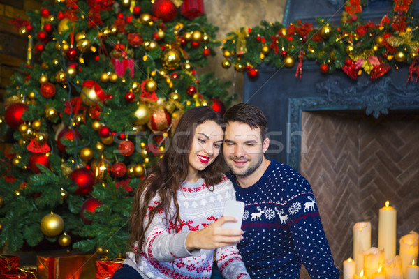 Young couple near fireplace celebrating Christmas Stock photo © dashapetrenko