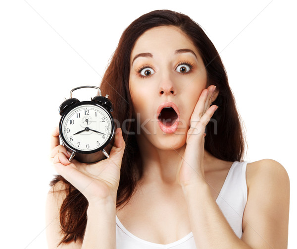Surprised young brunette woman holding clock  Stock photo © dashapetrenko