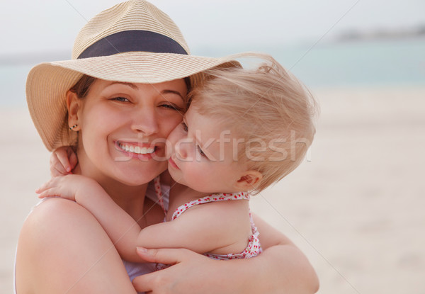 Portrait of mother holding her bay girl at beach  Stock photo © dashapetrenko