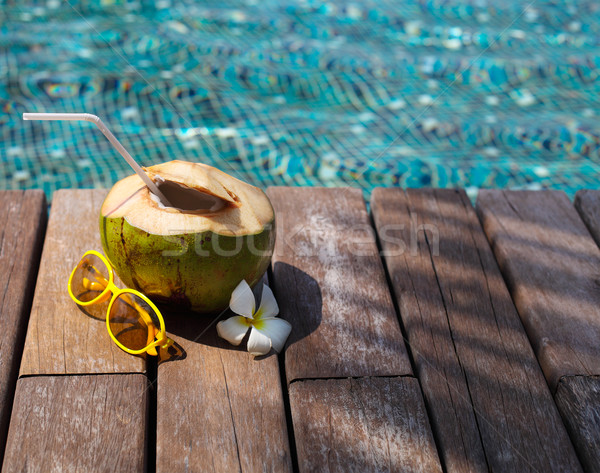 Coconut cocktail with drinking straw by the swimming pool Stock photo © dashapetrenko