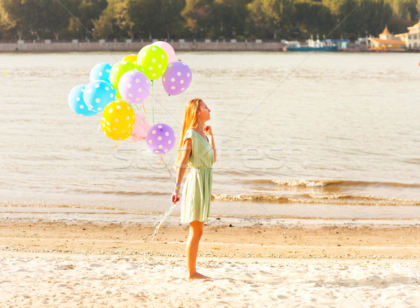 Woman on the beach with colored polka dots balloons Stock photo © dashapetrenko