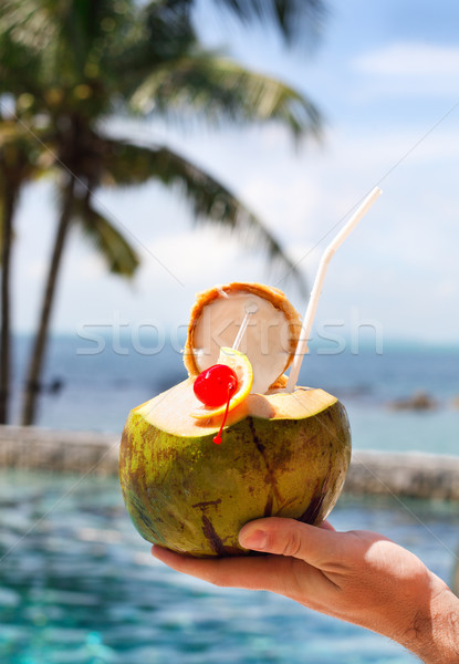 Man holding coconut cocktail with drinking straw and cocktail ch Stock photo © dashapetrenko