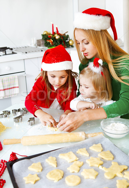 Two adorable girls and mother baking Christmas cookies  Stock photo © dashapetrenko