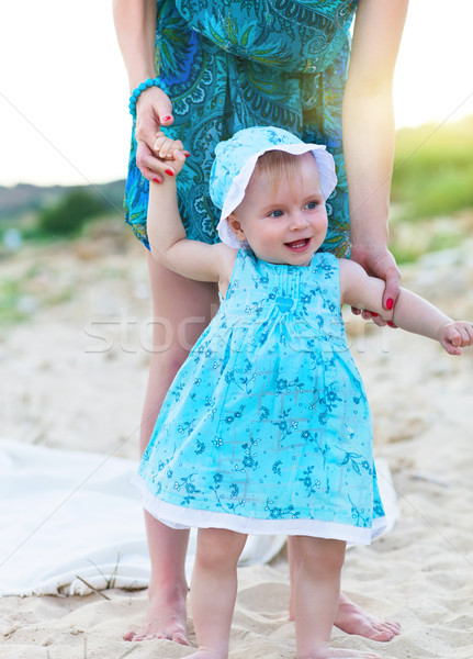 Mother and her baby girl having fun at the beach Stock photo © dashapetrenko