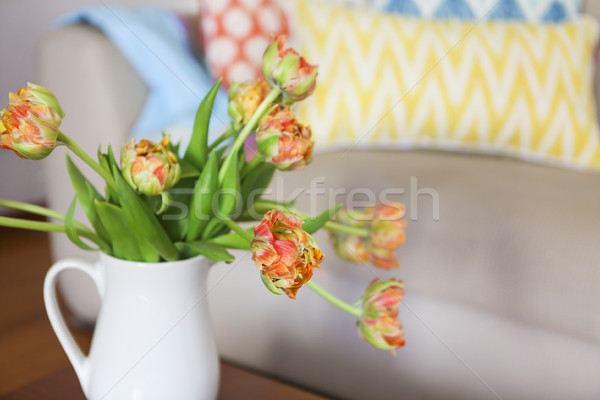 Beautiful orange tulips bouquet on wooden table in the living ro Stock photo © dashapetrenko