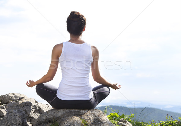 Attractive young woman doing a yoga pose  Stock photo © dashapetrenko