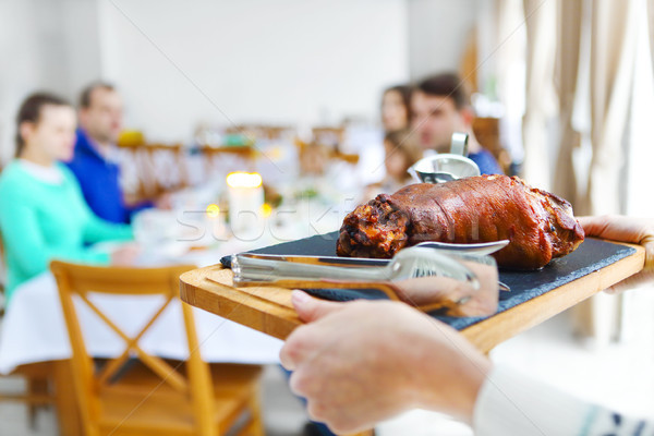 Stock photo: Friends sitting around a table and enjoying Christmas dinner tog