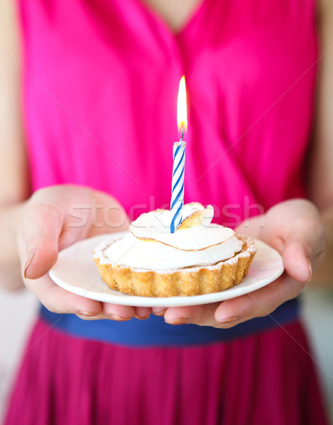 Lovely girl holding in hands cupcake with one candle. Birthday p Stock photo © dashapetrenko