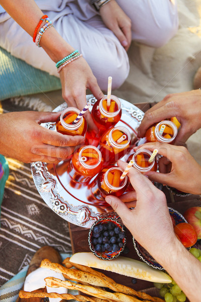 Group of friends holding drinks at the summer picnic Stock photo © dashapetrenko