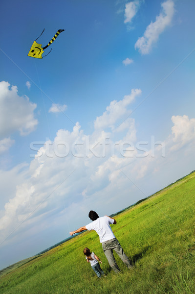 Little girl and her father with flying a kite  Stock photo © dashapetrenko