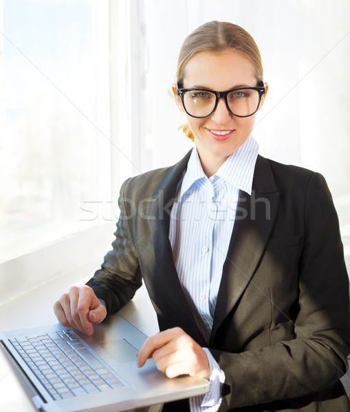 Young pretty business woman wearing eyeglasses with notebook Stock photo © dashapetrenko