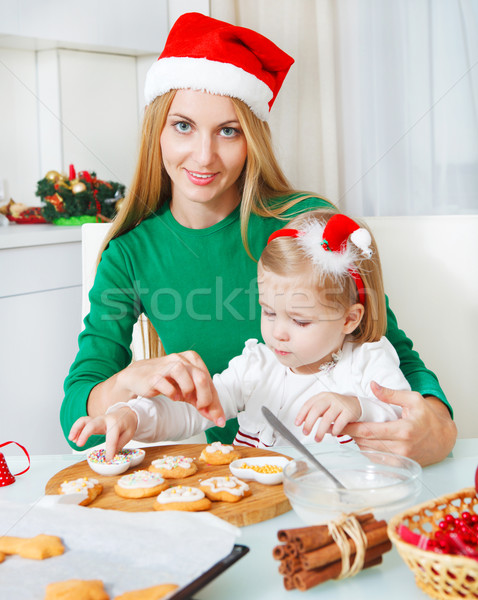 Adorable little girl with her mother baking Christmas cookies  Stock photo © dashapetrenko