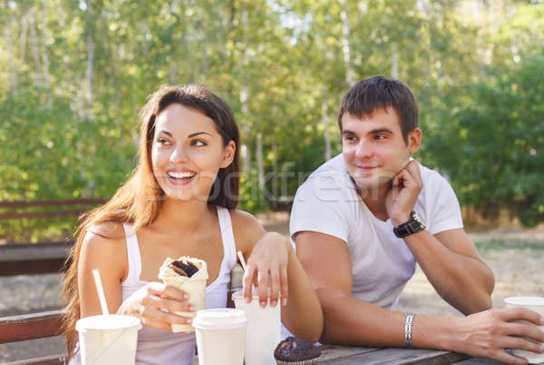 Man and woman or young couple drinking coffee in city park  Stock photo © dashapetrenko