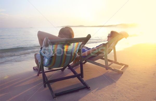 Stock photo: Happy couple sitting at sun chairs on the beach of Koh Samet at 
