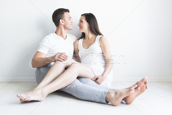 Young man and pretty pregnant woman hugging together Stock photo © dashapetrenko