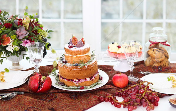 Dessert table for a wedding. Cake, cupcakes, sweetness and flowe Stock photo © dashapetrenko