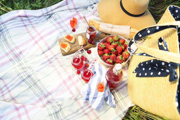 Basket, sandwiches, plaid and juice in a poppy field Stock photo © dashapetrenko