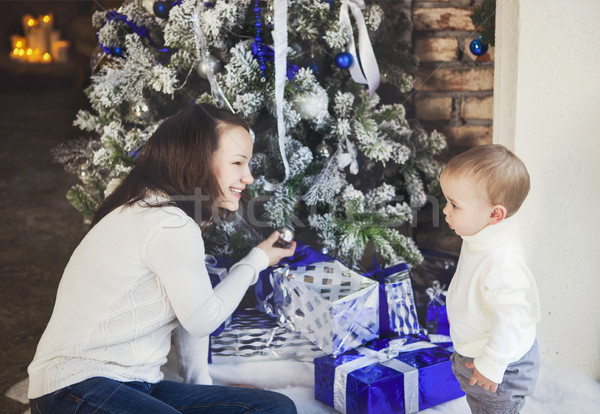 Mother with her baby boy siting near the Christmas tree Stock photo © dashapetrenko