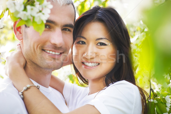 Stock photo: Happy smiling couple in love in spring garden