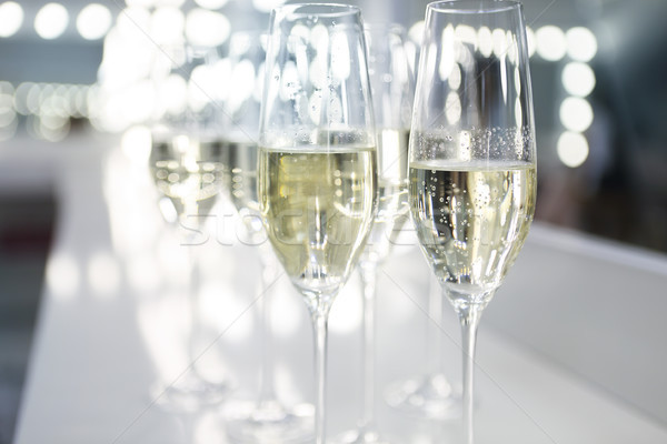 Champagne glasses on white background in bright lights Stock photo © dashapetrenko