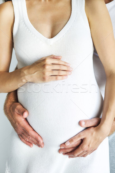 Young man and pretty pregnant woman hugging together Stock photo © dashapetrenko