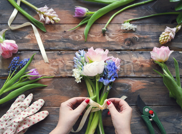 Stock photo: Florist at work. Woman making bouquet of spring flowers 