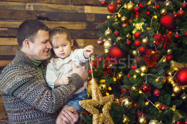 Father and his little daughter decorating the Christmas tree at  Stock photo © dashapetrenko