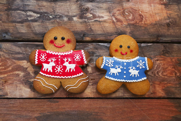 Smiling christmas gingerbread men on wooden background.  Stock photo © dashapetrenko