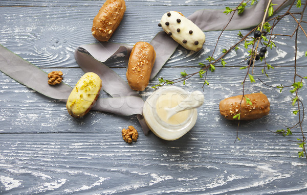 Eclairs with chocolate and whipped cream on dark background Stock photo © dashapetrenko