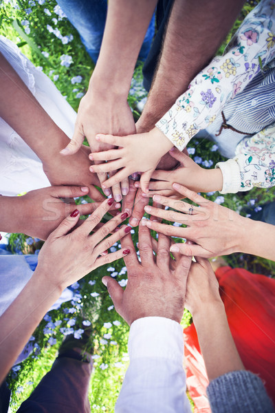 Group of friends with their hands in a complete circle Stock photo © dashapetrenko