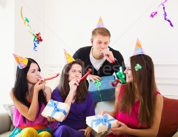 Joyful girl at birthday party surrounded by friends at party Stock photo © dashapetrenko