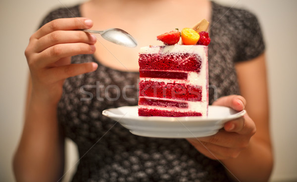 Woman holding plate with sliced red velvet cake Stock photo © dashapetrenko