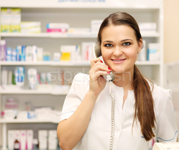 Smiling female pharmacist on the phone at drugstore Stock photo © dashapetrenko