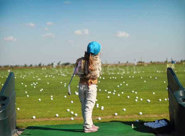 Luttle girl swinging golf club Stock photo © dashapetrenko