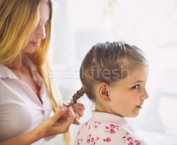 Mother hairdressing her preteen daughter at home Stock photo © dashapetrenko