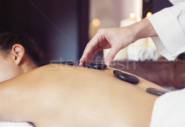 Hot stone massage therapy. Spa treatment Stock photo © dashapetrenko