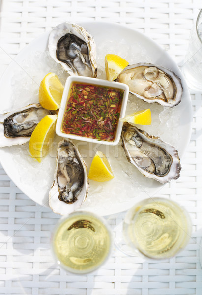 Selective focus point on fresh oysters shell with lemon and glas Stock photo © dashapetrenko