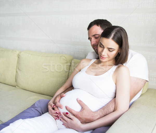 Pregnant woman and young man together indoors Stock photo © dashapetrenko