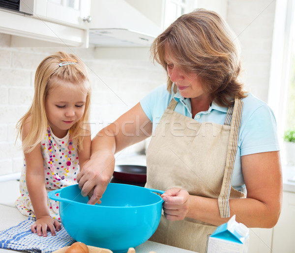 Little girl baking with her grandmother at home Stock photo © dashapetrenko