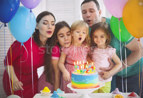 Portrait of a family celebrating birthday of their little daught Stock photo © dashapetrenko