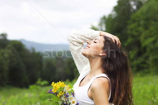 Stock photo: Happy pretty brunette woman in chamomile field