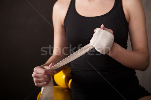 Woman boxer wearing white strap on wrist Stock photo © dashapetrenko