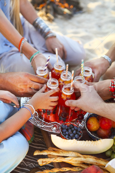 Group of friends holding drinks at the summer picnic Stock photo © dashapetrenko