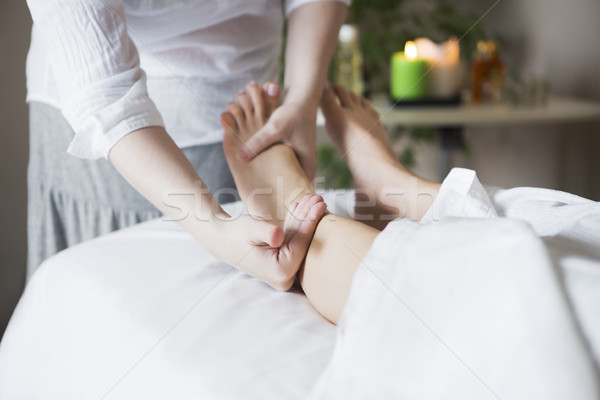 Foot massage treatment in asian spa salon Stock photo © dashapetrenko