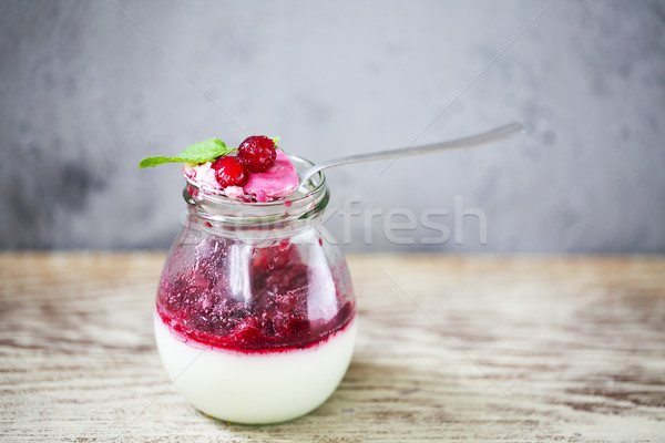 Vanilla panna cotta dessert with red berry sauce and mint in a j Stock photo © dashapetrenko
