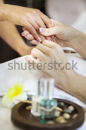 Woman in nail salon receiving manicure by beautician Stock photo © dashapetrenko