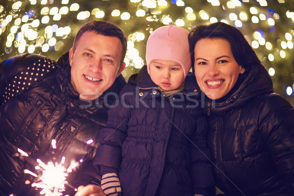 Family with Bengal light outside over Christmas background Stock photo © dashapetrenko