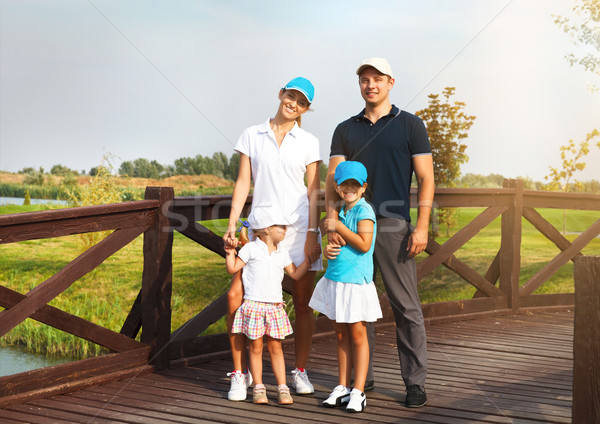 Portrait of a happy young family in golf club Stock photo © dashapetrenko
