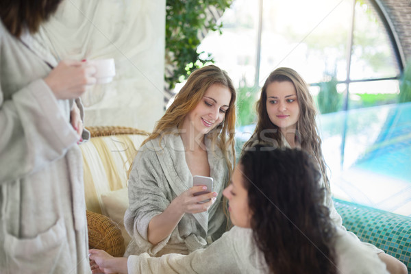 Four young women drinking tea at spa resort Stock photo © dashapetrenko